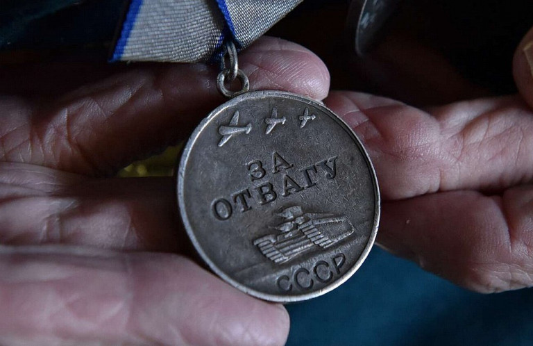  Заглавная иллюстрация: самая главная солдатская медаль в натруженных руках солдата.